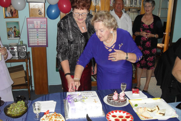 Eve & Glenys cutting the 80th anniversary cake