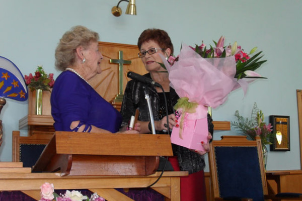 Glenys Lindsay presenting Eve Higgins with Flowers at the Church's 80th Anniversary